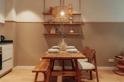a dining room with a wooden table and chairs at Casa Carlit - 1 bedroom apartment near Plaza Tetuán in Barcelona