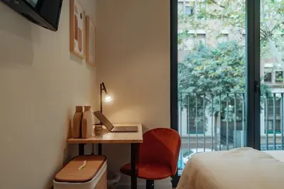 a bedroom with a desk with a laptop and a chair at Casa Carlit - 1 bedroom apartment near Plaza Tetuán in Barcelona