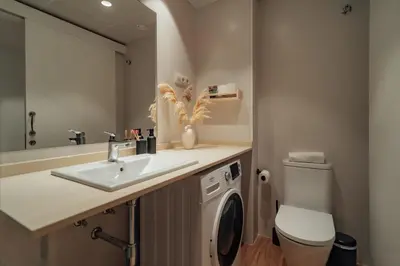 a bathroom with a sink and a washing machine at Casa Carlit - 1 bedroom apartment near Plaza Tetuán in Barcelona