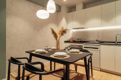 a dining room with a table and chairs in a kitchen at Casa Castaner in Barcelona