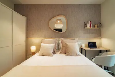 a bedroom with a bed with a mirror and a desk at Casa Castaner in Barcelona