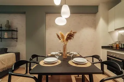 a dining room with a black table and chairs at Casa Castaner in Barcelona