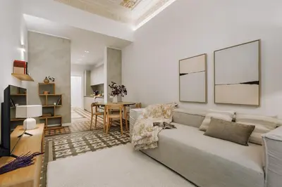 a living room with a couch and a table at Casa Comtal in Barcelona