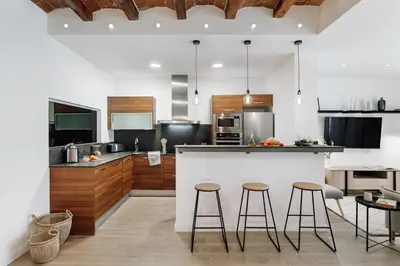 a kitchen with two bar stools and a counter at Casa Narciso in Barcelona