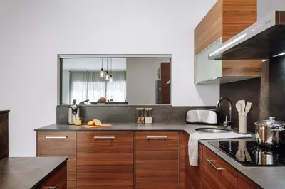 a kitchen with wooden cabinets and stainless steel appliances at Casa Narciso in Barcelona