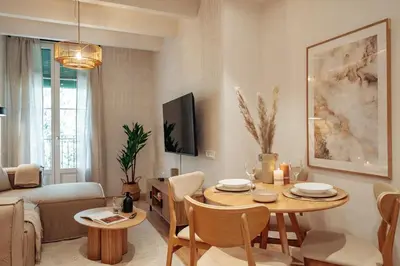 a living room with a table and a couch at Casa Dorada in Barcelona