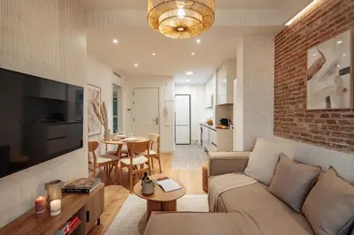 a living room with a couch and a table at Casa Dorada in Barcelona