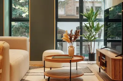 a living room with a table with a vase on it at Casa Duran in Barcelona