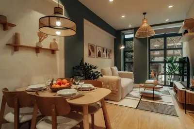 a kitchen and living room with a table and chairs at Casa Duran in Barcelona