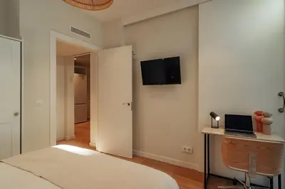 a bedroom with a bed and a laptop on a desk at Casa Duran in Barcelona