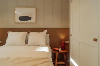a bedroom with a bed and a tv on the wall at Casa Duran in Barcelona