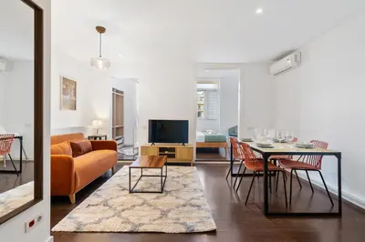 a living room with a table and a couch at Enrique Granados Apartment in Barcelona