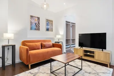 a living room with a couch and a flat screen tv at Enrique Granados Apartment in Barcelona