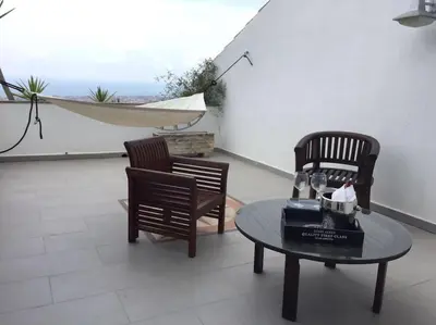 two chairs and a table on a patio at House Seaviews Barcelona 22Km in Cabrils