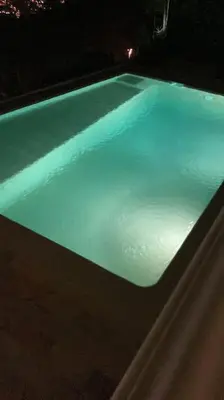 a swimming pool at night with blue lights at House Seaviews Barcelona 22Km in Cabrils