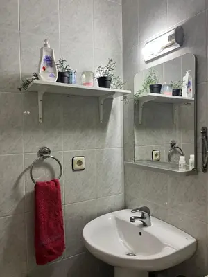 a bathroom with a sink and a red towel at Triumf in Barcelona