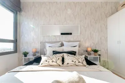 a bedroom with a large white bed in a room at Penthouse with Private Terrace & Pool Access in Cornellà de Llobregat