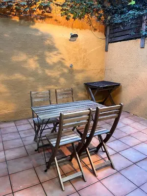 a wooden table and two chairs and a table and bench at MAB1 - Apartamento a pie de calle con terraza privada in Barcelona