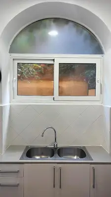 a kitchen with a sink and two windows at MAB1 - Apartamento a pie de calle con terraza privada in Barcelona