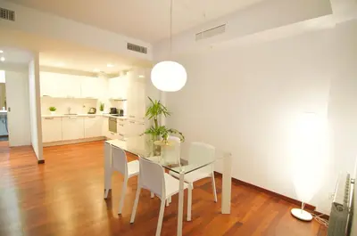 a dining room with a glass table and chairs at Glasir Homes Barcelona in Barcelona
