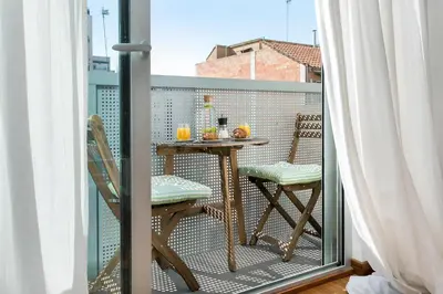 a balcony with a table and chairs on a balcony at Glasir Homes Barcelona in Barcelona