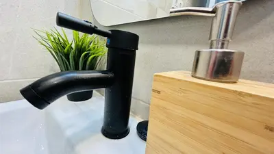 a black faucet on a sink in a bathroom at MaiFamilyBCN-Cómodo Y Para familia Y Metro Cercano in Badalona