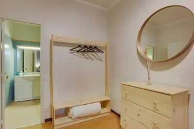 a bathroom with a mirror and a wooden dresser at Sant Joan entresol in Barcelona