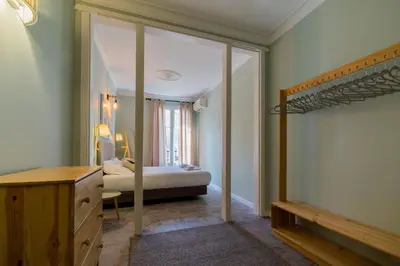 a room with a bedroom with a bed and a staircase at Sant Joan entresol in Barcelona