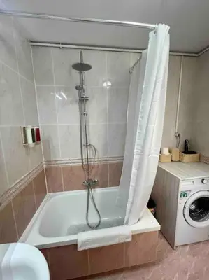 a bathroom with a bath tub with a washer at Plaza España - Central and quiet 2BR for couples, families and events in Barcelona