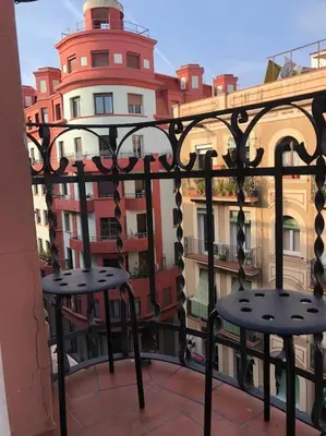 a balcony with two chairs and a building at Plaza España - Central and quiet 2BR for couples, families and events in Barcelona