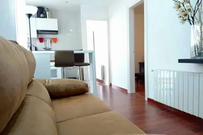 a living room with a couch and a kitchen at Plaza España - Central and quiet 2BR for couples, families and events in Barcelona