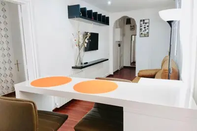 a living room with a white table with orange circles at Plaza España - Central and quiet 2BR for couples, families and events in Barcelona