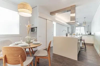 a kitchen and dining room with a table and chairs at Casa Gavina in Barcelona