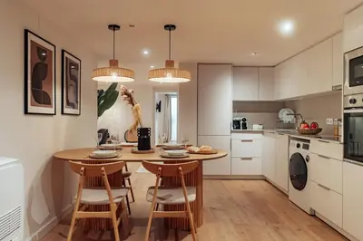 a kitchen with a table and chairs in a kitchen at Casa Goya in Barcelona