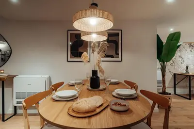 a dining room table with a large chandelier at Casa Goya in Barcelona