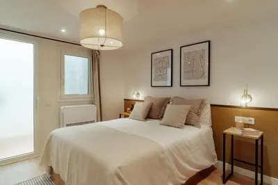 a bedroom with a large white bed and a window at Casa Goya in Barcelona