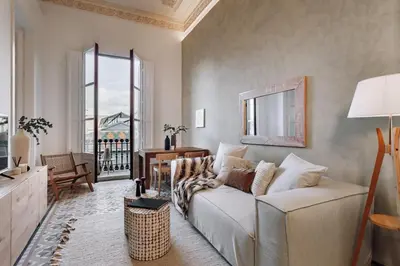 a living room with a white couch and a window at Casa Jordi in Barcelona