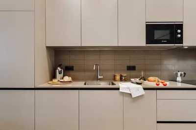 a kitchen with white cabinets and a plate of food at Casa Jordi in Barcelona