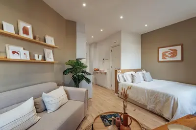 a living room with a bed and a couch at Casa Laietana in Barcelona