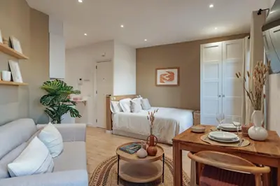 a living room with a bed and a table at Casa Laietana in Barcelona