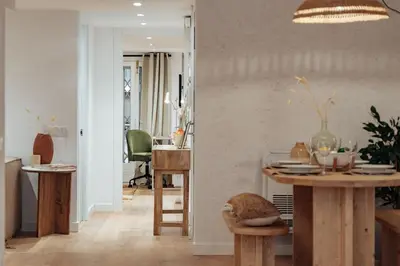 a living room with a table and a dining room at Casa Lennon in Barcelona