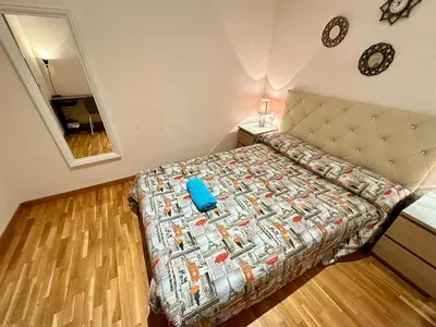 a bedroom with two beds with a blue pillow on it at Habitaciones acogedoras en Aragón in Barcelona