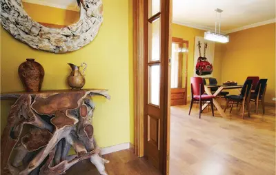 a dining room with a table and a mirror on the wall at Lovely Home In St Cebrià De Vallalta in Sant Cebrià de Vallalta