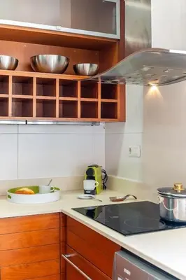 a kitchen with wooden cabinets and a counter top at Canela Homes BARCELONA ATIC in Barcelona