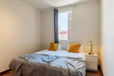 a bedroom with a bed and a window at Canela Homes BARCELONA ATIC in Barcelona