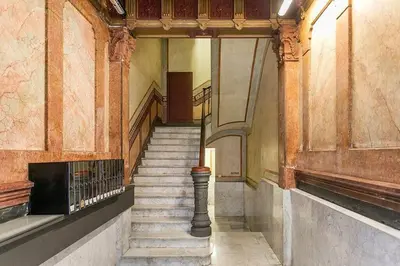 a staircase in an old building with a stair case at Canela Homes BARCELONA CONCEPCIÓ in Barcelona