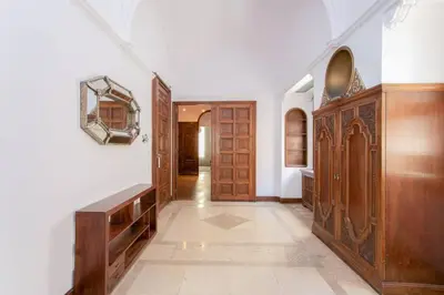 a hallway with wooden cabinets and a mirror on the wall at Canela Homes BARCELONA CASA SERRA in Barcelona