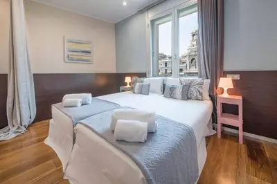 a bedroom with a large bed and a window at Canela Homes BARCELONA CENTRAL in Barcelona
