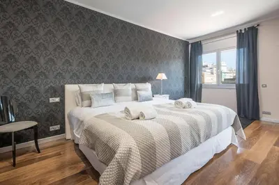 a bedroom with a large bed with two towels on it at Canela Homes BARCELONA CENTRAL in Barcelona