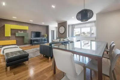 a dining room and living room with a table and chairs at Canela Homes BARCELONA CENTRAL in Barcelona